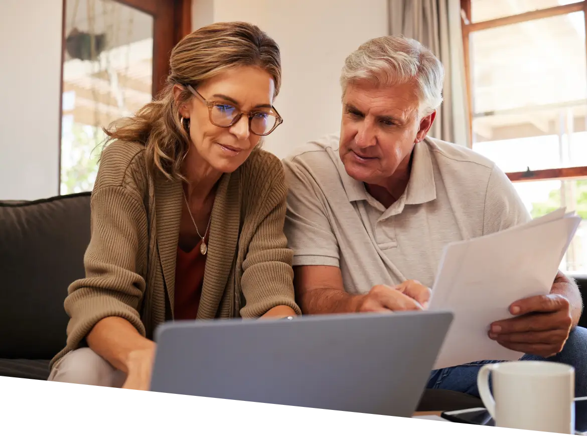 couple looking at a document while sitting on a couch